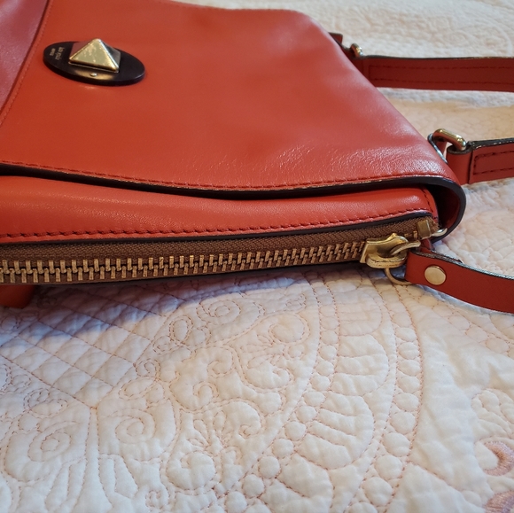 Kate Spade orange leather purse.  12" x 9" Two side zippers three inside pockets - Picture 6 of 11